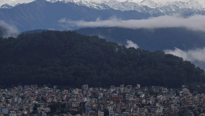 A snowcapped mountain range emerges over the valley as monsoon clouds clear following heavy rainfall in Kathmandu on 5 October 2025. | Navesh Chitrakar | Reuters