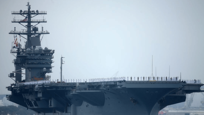 FILE PHOTO: Sailors man the rails as aircraft carrier USS Nimitz with Carrier Strike Group 11, and some 7,500 sailors and airmen depart for a 6 month deployment in the Western Pacific from San Diego, California, U.S., June 5, 2017. REUTERS