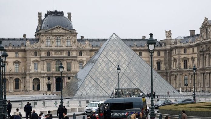 Police near the pyramid of the Louvre museum after reports of a robbery, in Paris, France, October 19, 2025 | Reuters