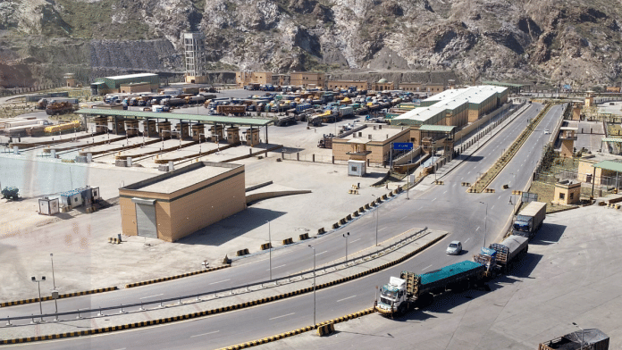 Trucks stand parked at Torkham border crossing after Pakistan closed border crossings with Afghanistan following exchanges of fire between forces of the two countries. | Shahid Shinwari/Reuters