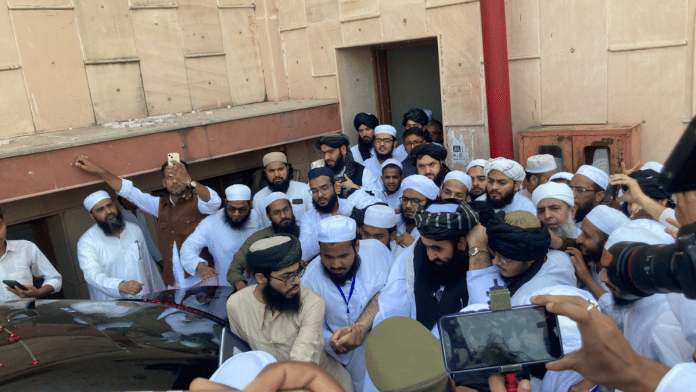 Acting Foreign Minister of Afghanistan Amir Khan Muttaqi (striped turban) exits the library at Darul Uloom on Saturday | Keshav Padmanabhan | ThePrint