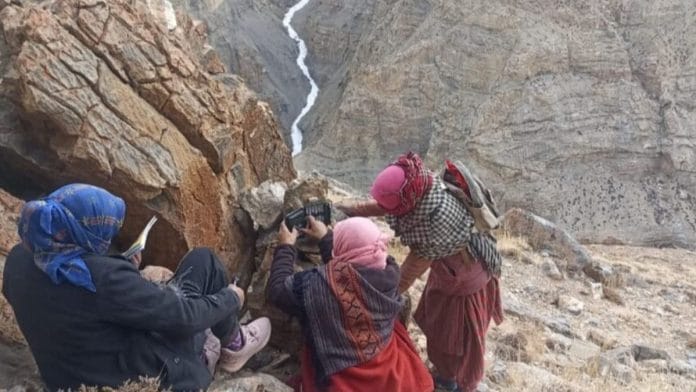 Women from Kibber village set up a camera trap on a steep slope in Spiti Valley during the state-wide snow leopard survey. Image courtesy of Wildlife wing- Himachal Pradesh Forest Department and the Nature Conservation Foundation | Mongabay India