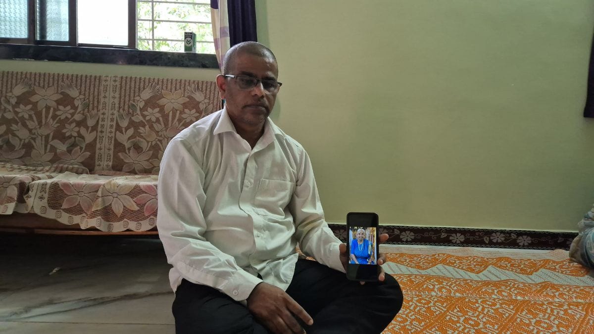 Moureshwar Gowardhan sits with a photograph of his mother that he lost in an accident on NH66 | Photo: Shubhangi Misra, ThePrint