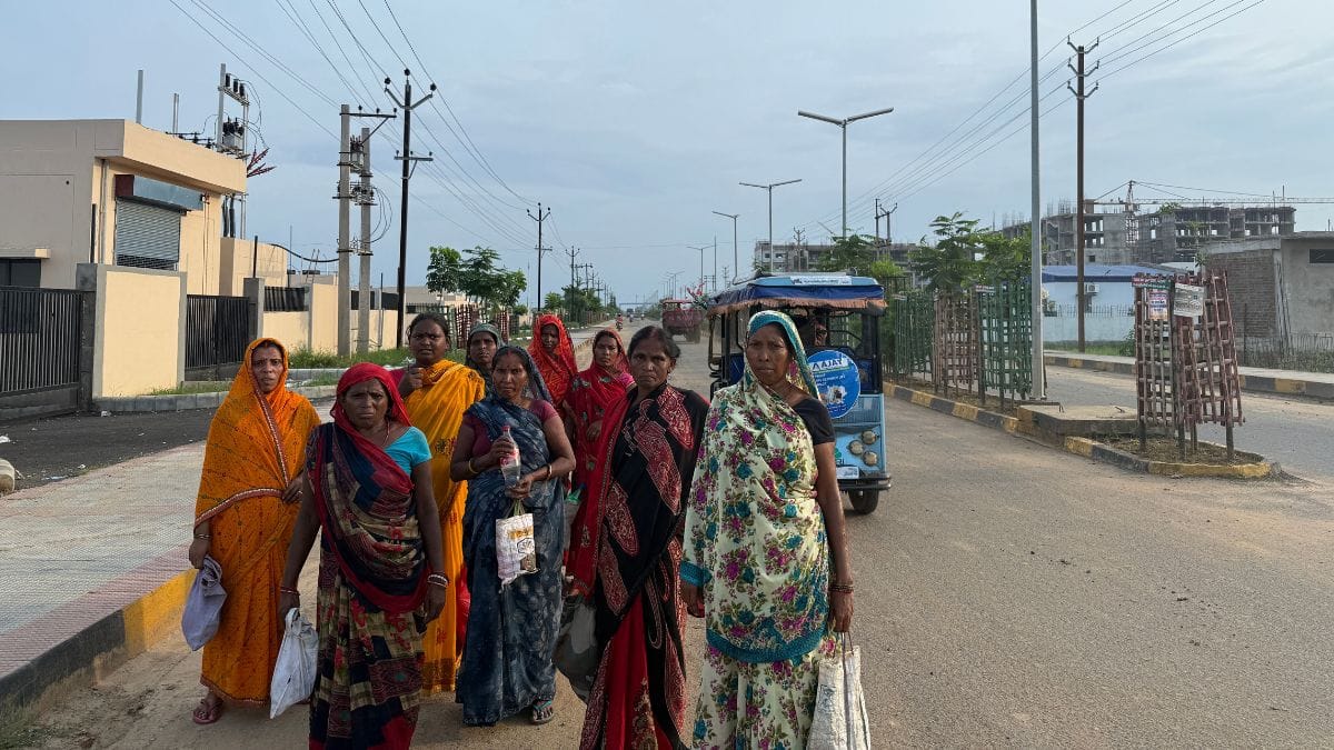 A group of women, sarees fluttering and tiffins swinging by their sides, walk out of the factories in the evening. They are the first in their families to hold factory jobs, while their husbands still labour at construction sites | Photo: Jyoti Yadav, ThePrint
