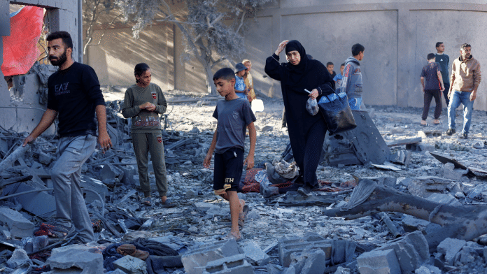 Palestinians inspect the site of an overnight Israeli strike on a house, in Nuseirat, central Gaza Strip, October 29, 2025 | Reuters
