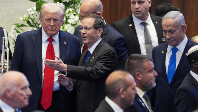 U.S. President Donald Trump enters the Knesset, with Israel's President Isaac Herzog and Israel's Prime Minister Benjamin Netanyahu on 13 October 2025, in Jerusalem. | Evan Vucci | Pool via Reuters