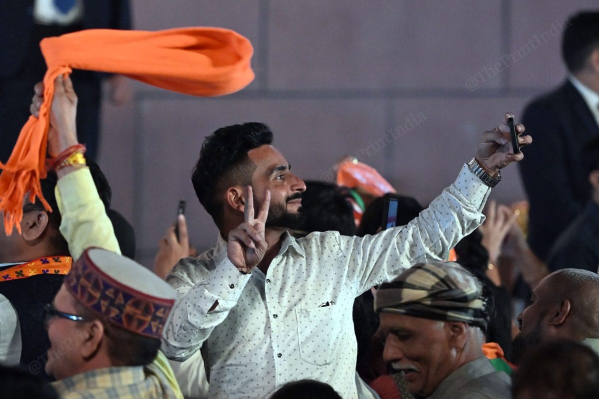 BJP suppoters taking selfie while PM Modi addressing party suppoters at BJP HQ | Suraj Singh Bisht | ThePrint