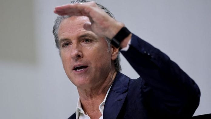 California Governor Gavin Newsom gestures as he attends a press conference, during the UN Climate Change Conference (COP30), in Belem on 11 November 2025. | Adriano Machado | Reuters
