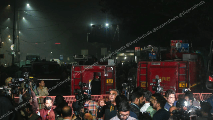 Reporters and investigators near the blast site on Monday evening | ThePrint/Suraj Singh Bisht