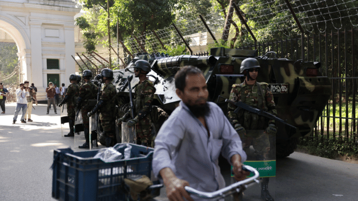 Army members stand guard in front of the court as government increased security measures in Dhaka, on 17 November 2025. | Mohammad Ponir Hossain | Reuters