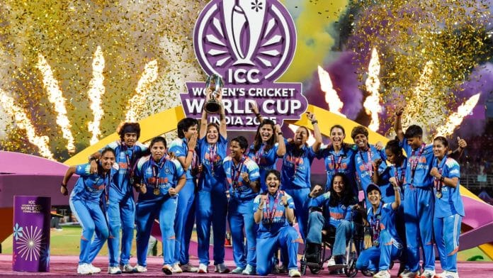 Women's cricket team celebrate with the trophy at DY Patil Sports Academy, in Navi Mumbai, on 3 November 2025 | ANI