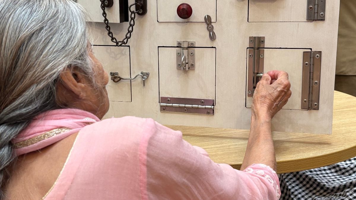 Residents practice opening and closing different types of latches during a daily activity, guided by an occupational therapist to strengthen motor and cognitive skills | Sakshi Mehra, ThePrint