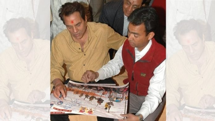 Dharmendra looking over a poster during his Bikaner campaign in 2004 | Photo courtesy of Laxman Raghav