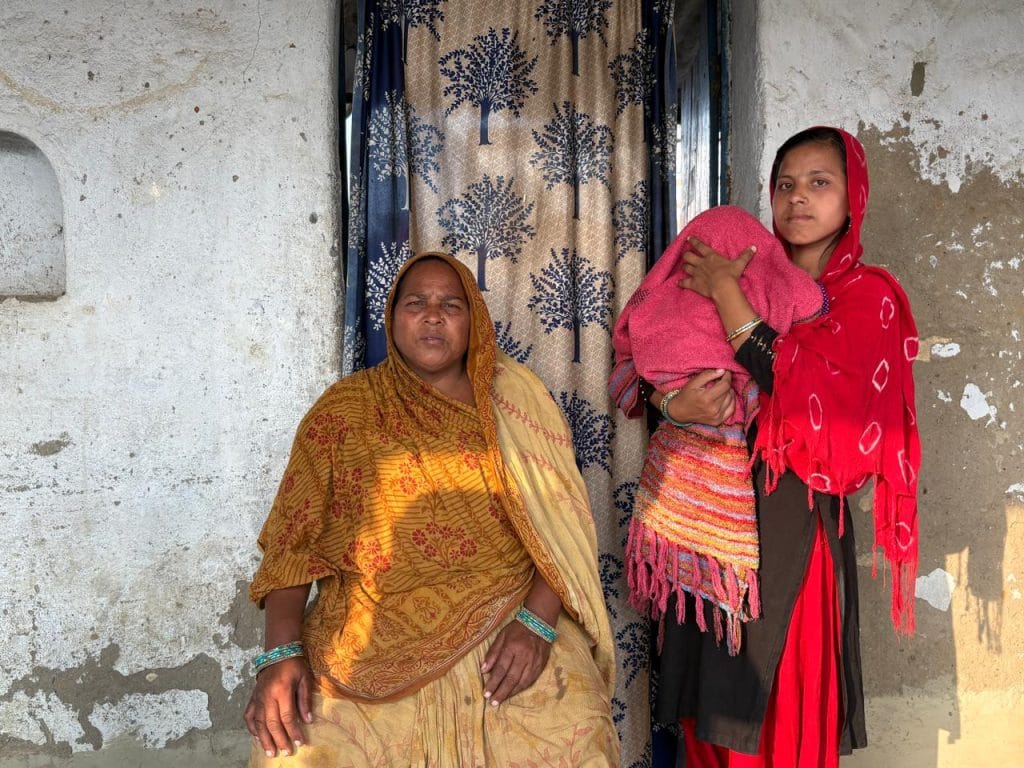 Asma Khatun with her daughter and granddaughter at their home in Muzaffarnagar district. Her husband died by suicide after alleged harassment over loan repayments | Photo: Sakshi Mehra | ThePrint