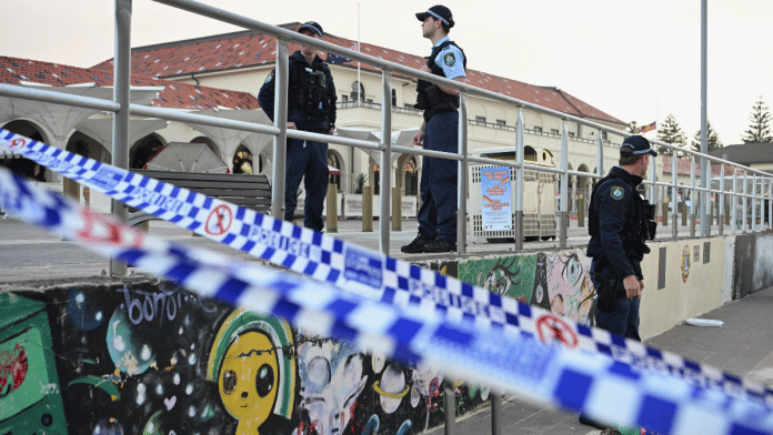 Police officers stand guard following the attack on a Jewish holiday celebration at Sydney's Bondi Beach, in Sydney on 15 December 2025. | Flavio Brancaleone | Reuters