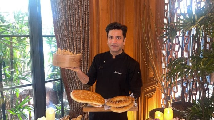 Chef Kunal Kapur poses with flatbreads at One8 Commune, where he’s hosting a week long pop-up—The Saudi Table 