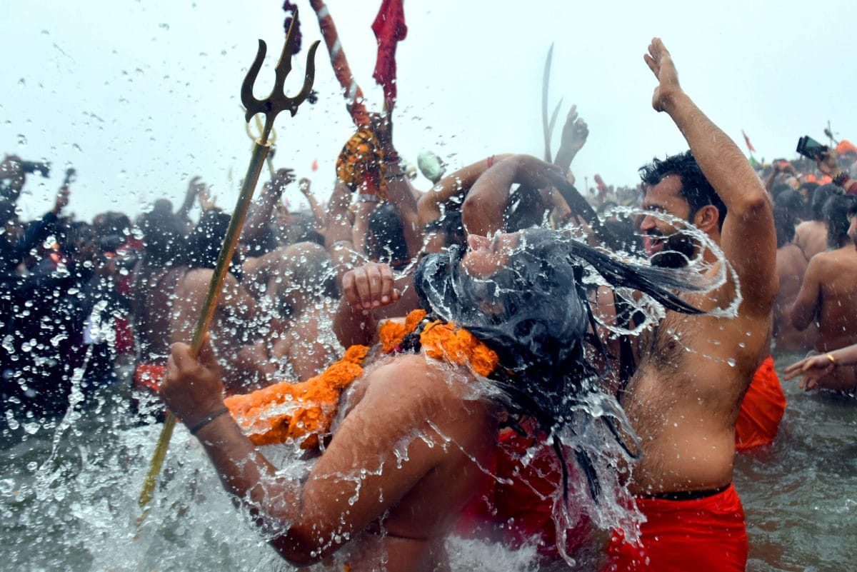 Naga Sadhu's take a holy dip at Sangam on the occasion of Makar Sakranti, the confluence of the Ganges, Yamuna and Saraswati rivers, during the "Maha Kumbh Mela" in Prayagraj, Uttar Pradesh | Suraj Singh Bisht | ThePrint
