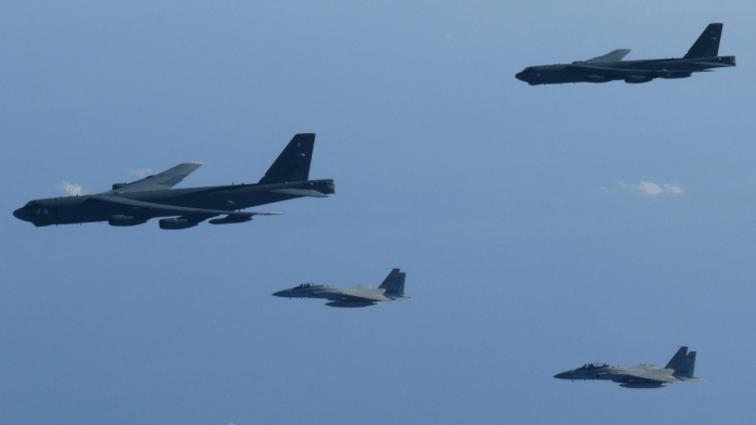 The 6th Air Wing of Japan Air Self-Defense Force's F-15 fighters hold a joint military drill with the U.S. B-52 bombers over Sea of Japan, in this handout picture taken by Japan Air Self-Defence Force and on December 10, 2025, and released by the Joint Staff Office of the Defense Ministry of Japan on December 11, 2025. Joint Staff Office of the Defense Ministry of Japan/Handout via Reuters