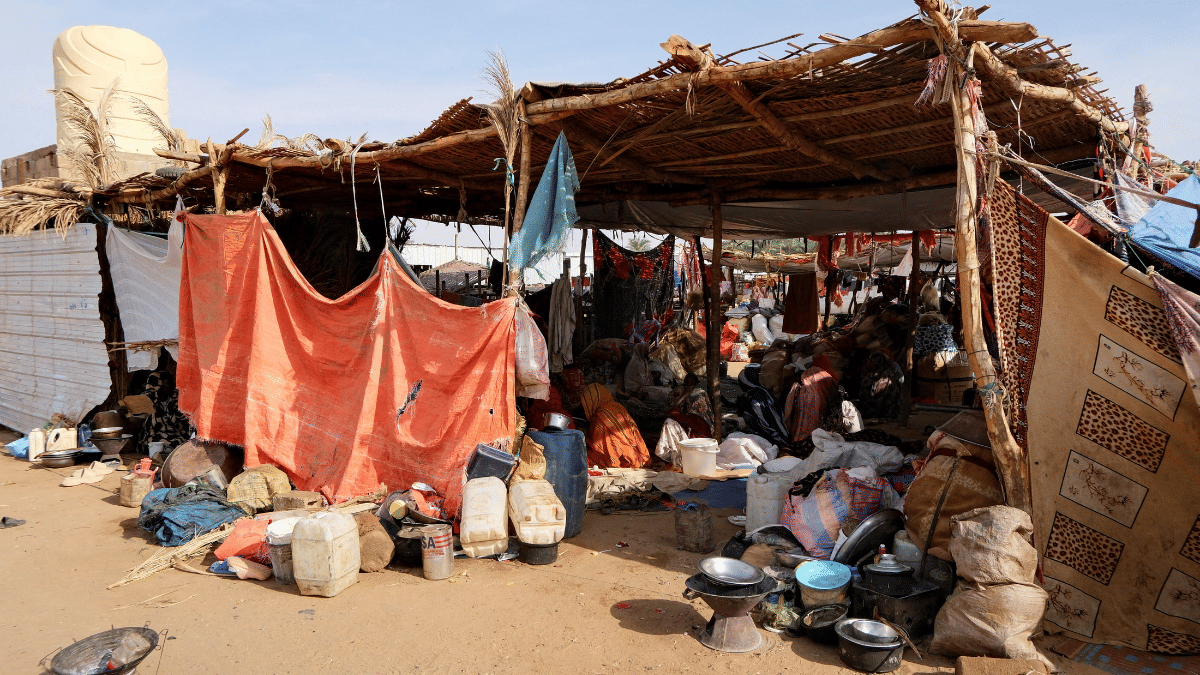 File photo of Sudanese women, who fled intense fighting in Sudan's El-Fashir, sit in a tent made of straw and tree branches at a displacement camp | Reuters
