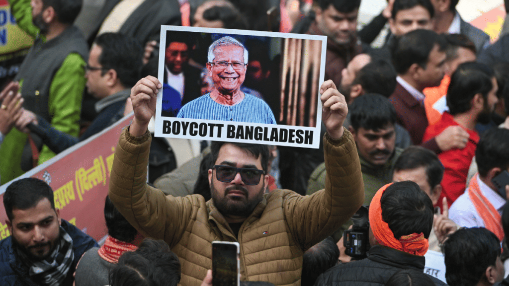 A man holds up a 'Boycott Bangladesh' placard at a protest near the Bangladesh High Commission in New Delhi. VHP protesters on Tuesday clashed with police and broke barricades near the embassy over the lynching of Dipu Chandra Das, a Hindu youth in Bangladesh. | Suraj Singh Bisht | ThePrint