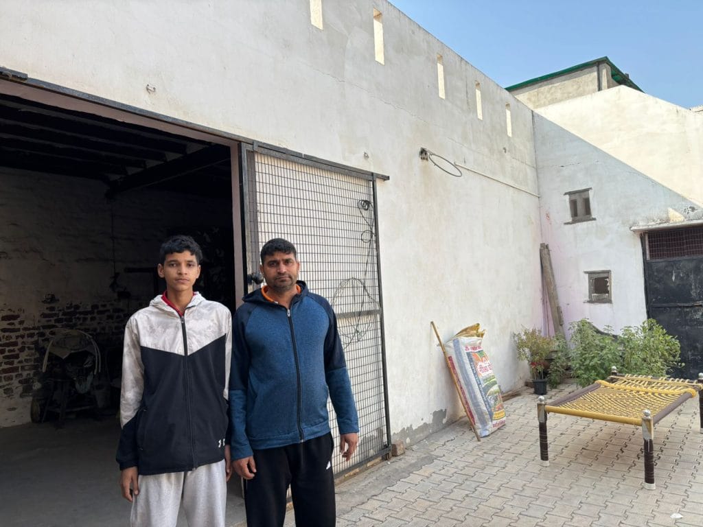 Hardik's father (right) with his younger brother outside their house. Samridhi Tewari | ThePrint