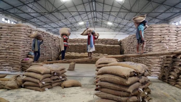 File photo of workers unloading sacks of foodgrain in a godown | Representational image | ANI