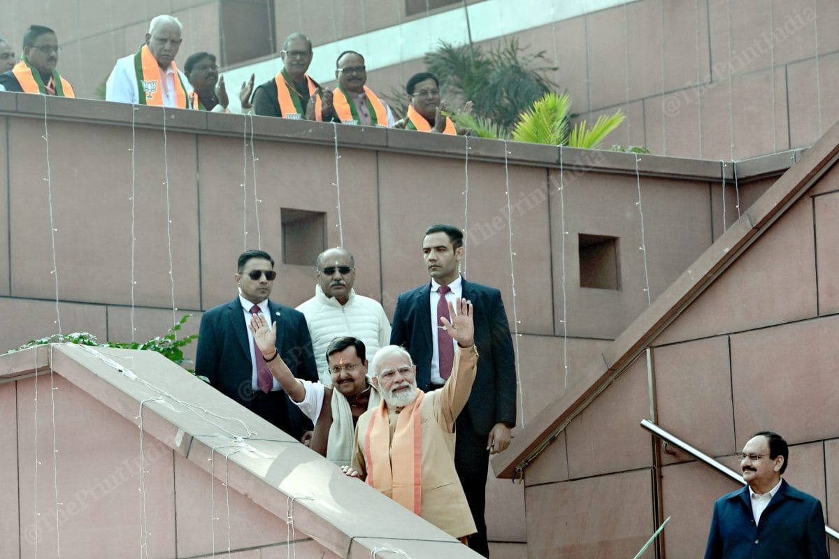 PM Narendra Modi and newly elected BJP national president Nitin Nabin greet supporters at the party headquarters as outgoing president J.P. Nadda looks on. | Suraj Singh Bisht/ThePrint