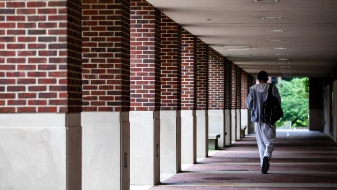 A student near Hatcher Graduate Library at the University of Michigan in Ann Arbor, Michigan, US, on Monday, July 28, 2025. The Department of Education said it opened investigations into five universities to determine whether the schools were granting scholarships only for undocumented students as the Trump administration expands its immigration crackdown and efforts to overhaul US higher education. Photographer: Emily Elconin/Bloomberg