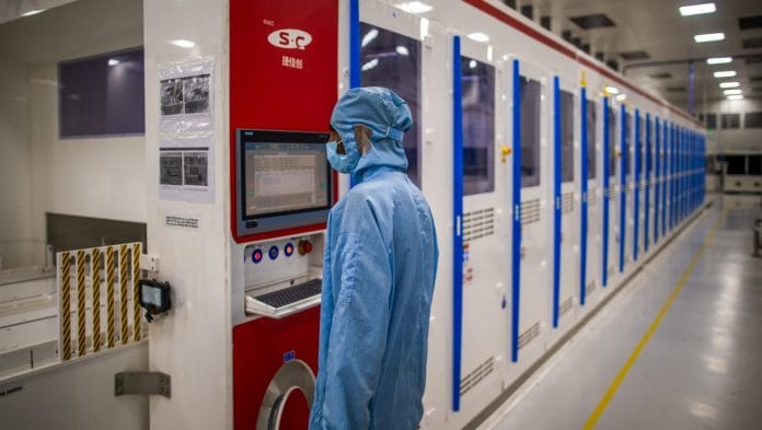 An employee works at the solar cells and modules manufacturing facility of Adani Group in Mundra, Gujarat, India, on Monday, Oct. 30, 2023 | Bloomberg