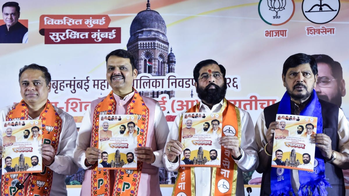 Maharashtra CM Devendra Fadnavis with Dy CM Eknath Shinde and RPI (A) MP Ramdas Athawale during release of manifesto for BMC elections in Mumbai on 11 January 2026 | ANI