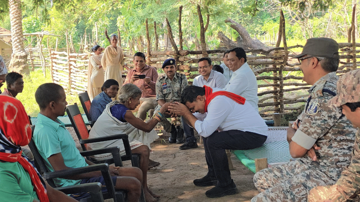 Chhattisgarh Home Minister Vijay Sharma with the mothers of Madvi Hidma and Barsa Deva during his visit to Sukma | X/@vijaysharmacg