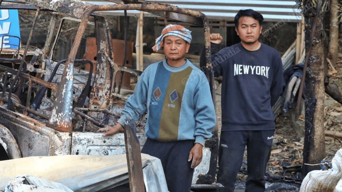 Kimeilen Haokip (right) and his father outside their burnt house | Praveen Jain | ThePrint
