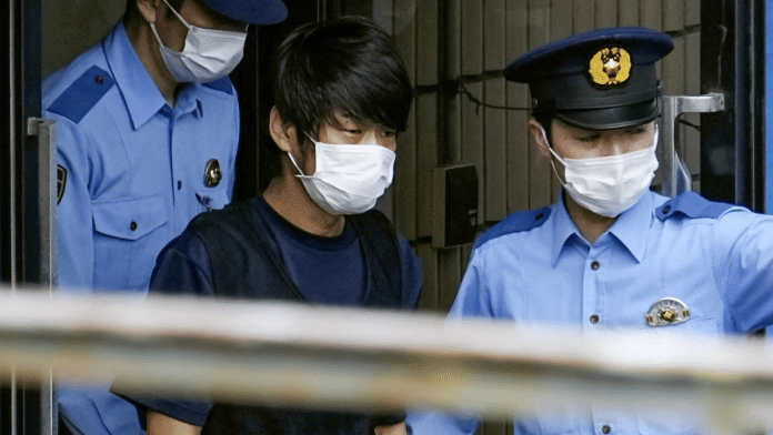 In this photo taken on 10 July 2022, Tetsuya Yamagami is escorted by police to prosecutors at Nara-nishi police station. | Kyodo via REUTERS
