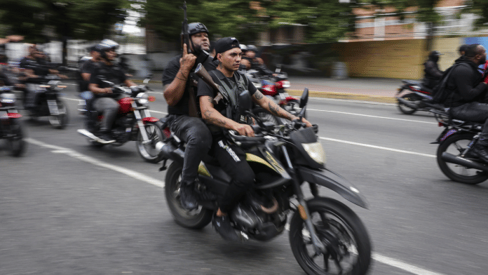 A caravan of armed men on motorcycles drives through the main streets of Caracas on Jan. 4, a day after the capture of Nicolás Maduro by US forces. Photographer: Jesus Vargas/Getty Images via BLOOMBERG