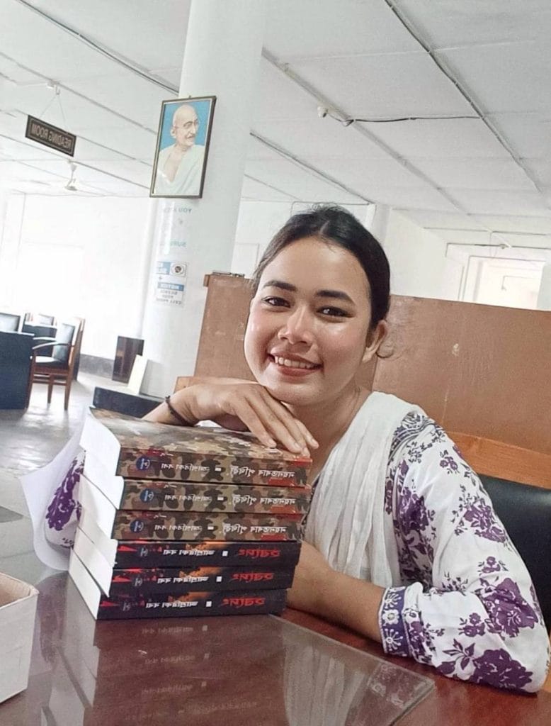 Aashrawika Borah with copies of her novels Nayantora'r Prithibi and Hardeng at a library | By special arrangement 