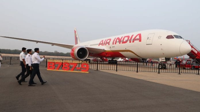 Three men walk past Air India's custom-built Boeing 787-9 Dreamliner on display at Wings India 2026 in Hyderabad | Almaas masood, ThePrint