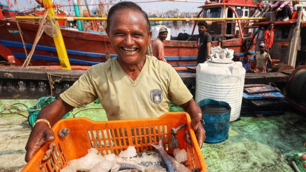 A fisherman showing off his catch. Manisha Mondal | ThePrint