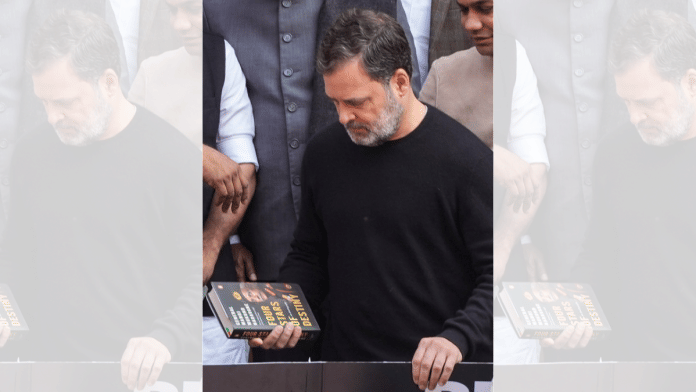 Leader of Opposition in the Lok Sabha Rahul Gandhi holds a copy of the unpublished 