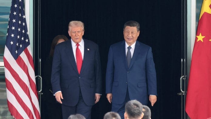 FILE PHOTO: U.S. President Donald Trump and Chinese President Xi Jinping walk as they leave after a bilateral meeting at Gimhae International Airport, on the sidelines of the Asia-Pacific Economic Cooperation (APEC) summit, in Busan, South Korea, October 30, 2025. REUTERS/Evelyn Hockstein/File Photo