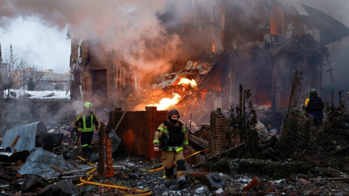 A firefighter works at the site of a residential building damaged during Russian drone and missile strikes, amid Russia's attack on Ukraine, in Kyiv, Ukraine, February 22, 2026. REUTERS/Alina Smutko