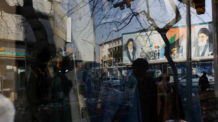 A sign with a depiction of Iran's Supreme Leader, Ayatollah Ali Khamenei, is reflected in a shop window in Tehran, Iran, February 19, 2026. Majid Asgaripour/WANA (West Asia News Agency) via REUTERS/File Photo