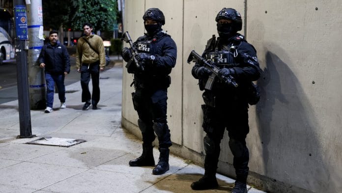 Security personnel stand guard outside the Specialized Prosecutor's Office for Organized Crime (FEMDO), where the body of El Mencho is suspected of being held by authorities, after a military operation in which a government source said Mexican drug lord Nemesio Oseguera, known as 