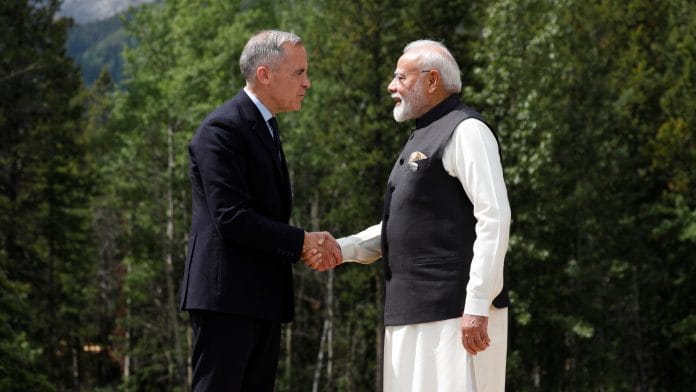 Canadian Prime Minister Mark Carney and India's Prime Minister Narendra Modi shake hands before posing for a photo during the G7 Leaders' Summit in Kananaskis, in Alberta, Canada, June 17, 2025. REUTERS/Amber Bracken