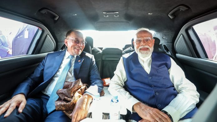 Kuala Lumpur [Malaysia], Feb 07 (ANI): Prime Minister Narendra Modi and Malaysian Prime Minister Anwar Ibrahim share a car to the community programme venue, in Kuala Lumpur on Saturday. (DPR PMO/ANI Photo)