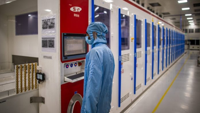 An employee works at the solar cells and modules manufacturing facility in Mundra, Gujarat, India | Bloomberg