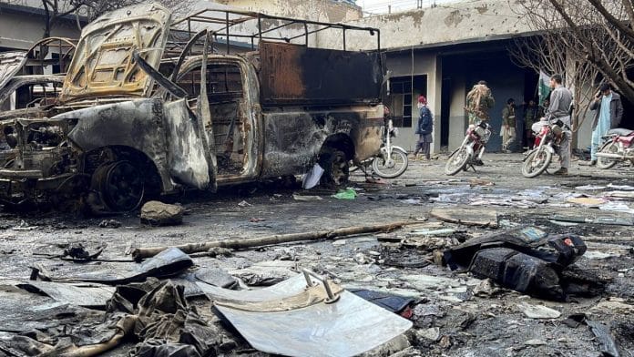 People walk amid the rubble at a police station following militant attacks in Quetta, Pakistan, on 1 February | Photo: Reuters
