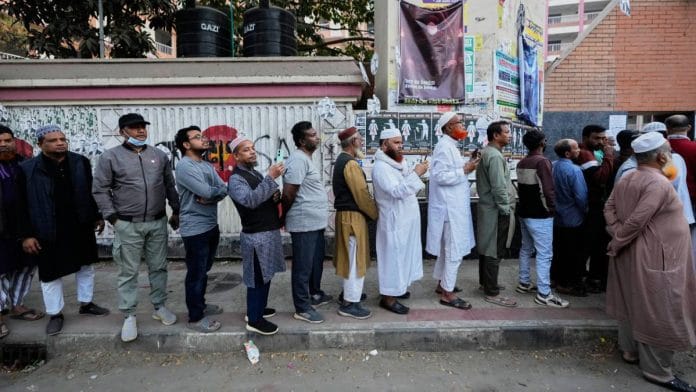 Bangladeshis stand in a queue to cast their votes at a polling station during national parliamentary election in Dhaka Thursday | AP/PTI