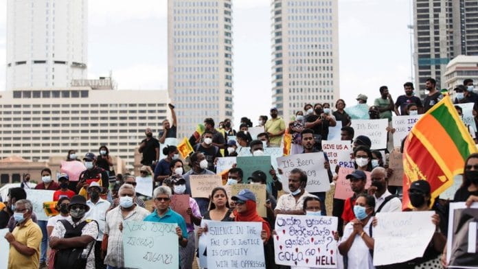 Demonstrators holding placards at a protest to demand justice for the April 2019 Easter Sunday bomb attack, on its third anniversary, near Presidential Secretariat in Colombo on 17 April 2022 | Navesh Chitrakar/Reuters