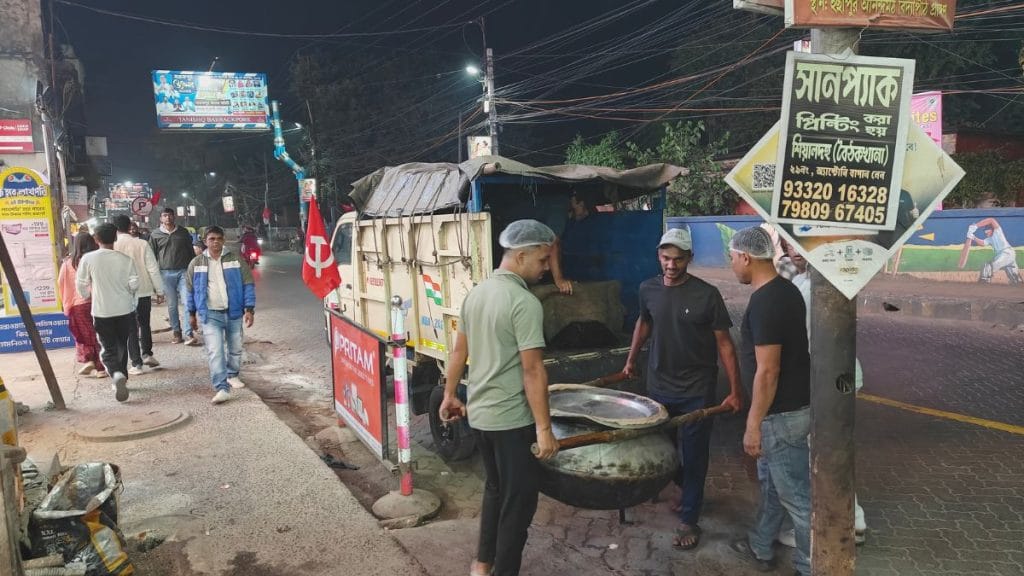 Workers unloading handis of biryani from a mini truck. Tina Das | ThePrint