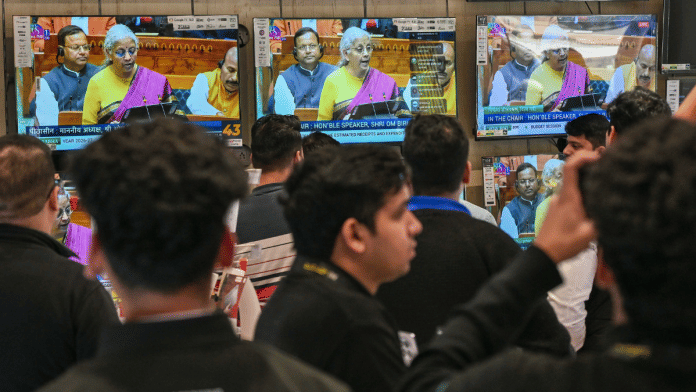 Bystanders watch Finance Minister Nirmala Sitharaman present the Union Budget 2026 in Parliament, New Delhi | Suraj Singh Bisht | ThePrint